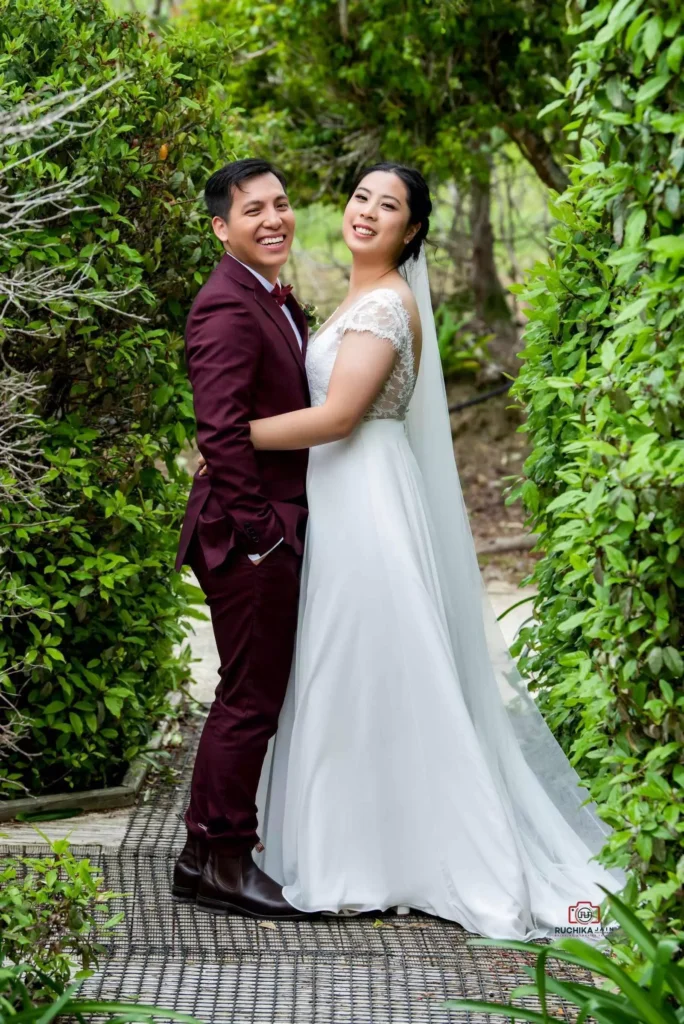 Wedding photography in Wellington: Happily married couple blushing in love while hugging each other