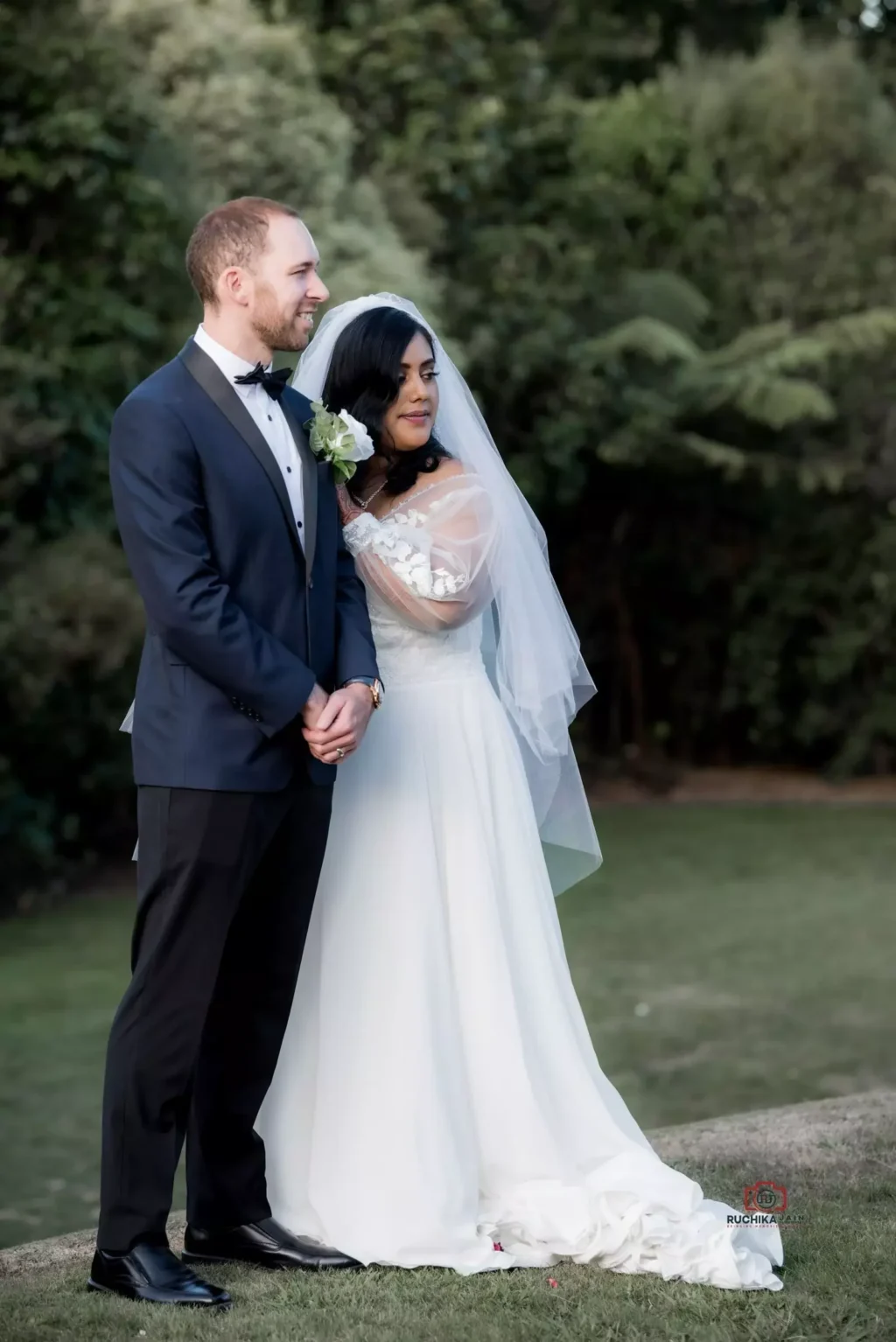 Bride placing her hand on groom's shoulder in outdoor wedding shoot - The Ultimate Wedding photography