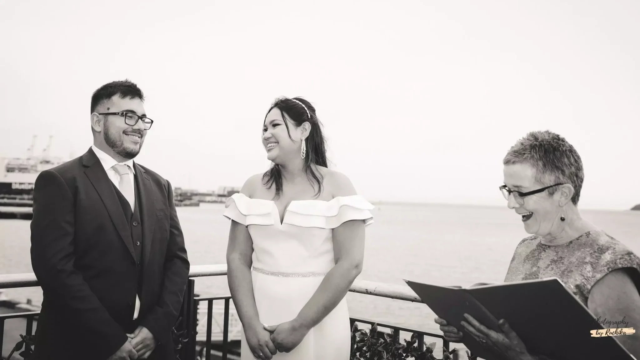 bride-and-groom-smiling-during-an-outdoor-wedding-ceremony-with-officiant