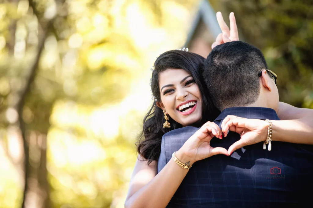 Bride playfully showing a heart gesture during a romantic outdoor engagement shoot in Wellington.