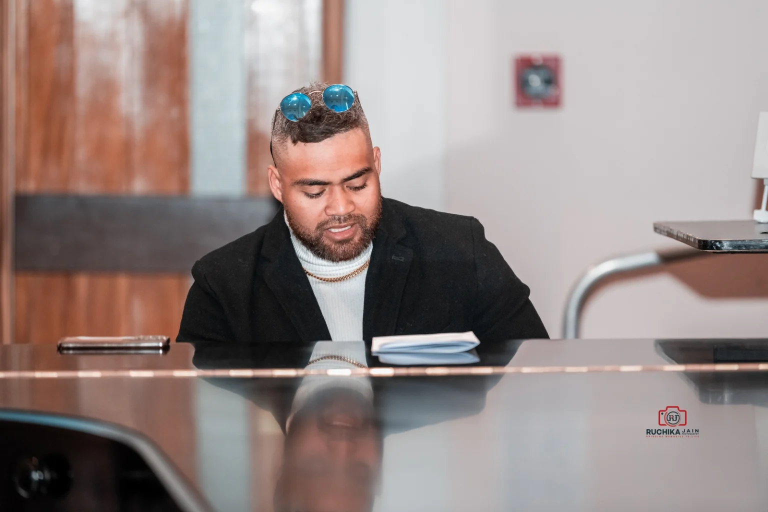 Pianist wearing sunglasses on his head plays music during a wedding ceremony