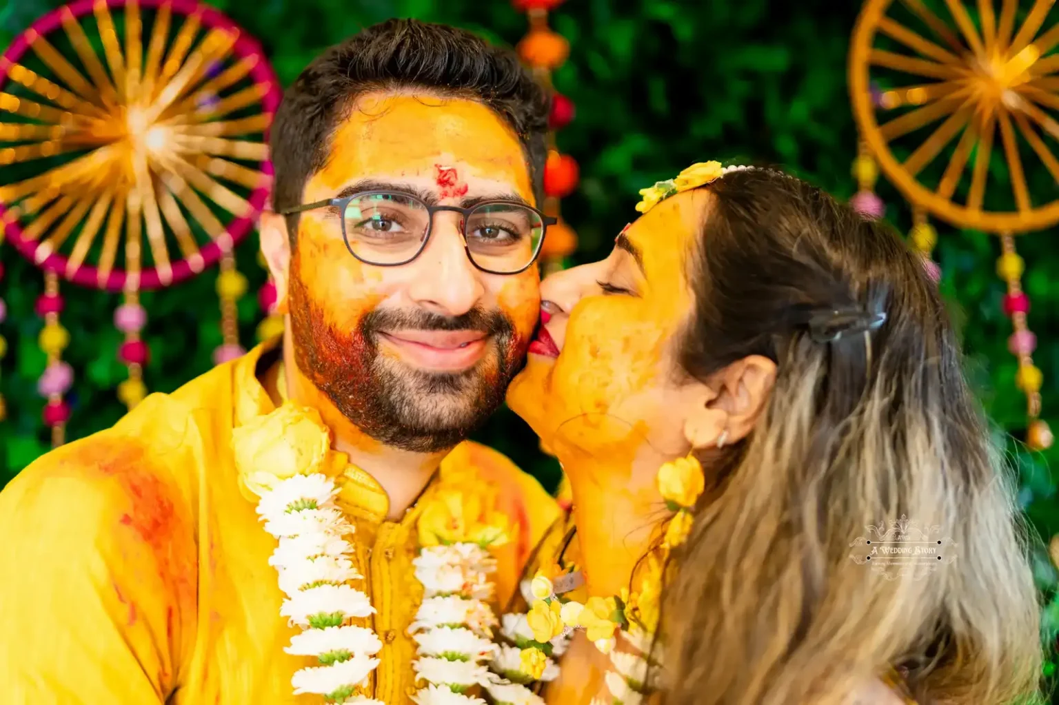 Bride kissing groom’s cheek during Haldi ceremony, captured by Wedding Photography in Wellington, New Zealand