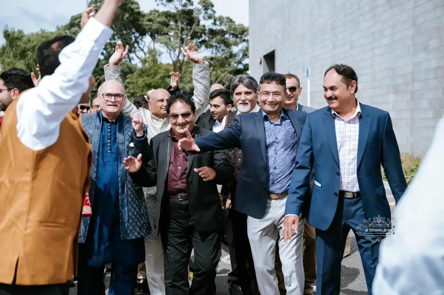 Group of men dancing and celebrating during a baraat procession at an Indian wedding in Wellington, captured by A Wedding Story