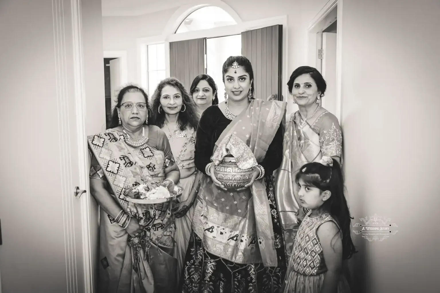 Bridal entrance with family members during a traditional wedding ceremony, captured in black and white by Wedding Photography in Wellington