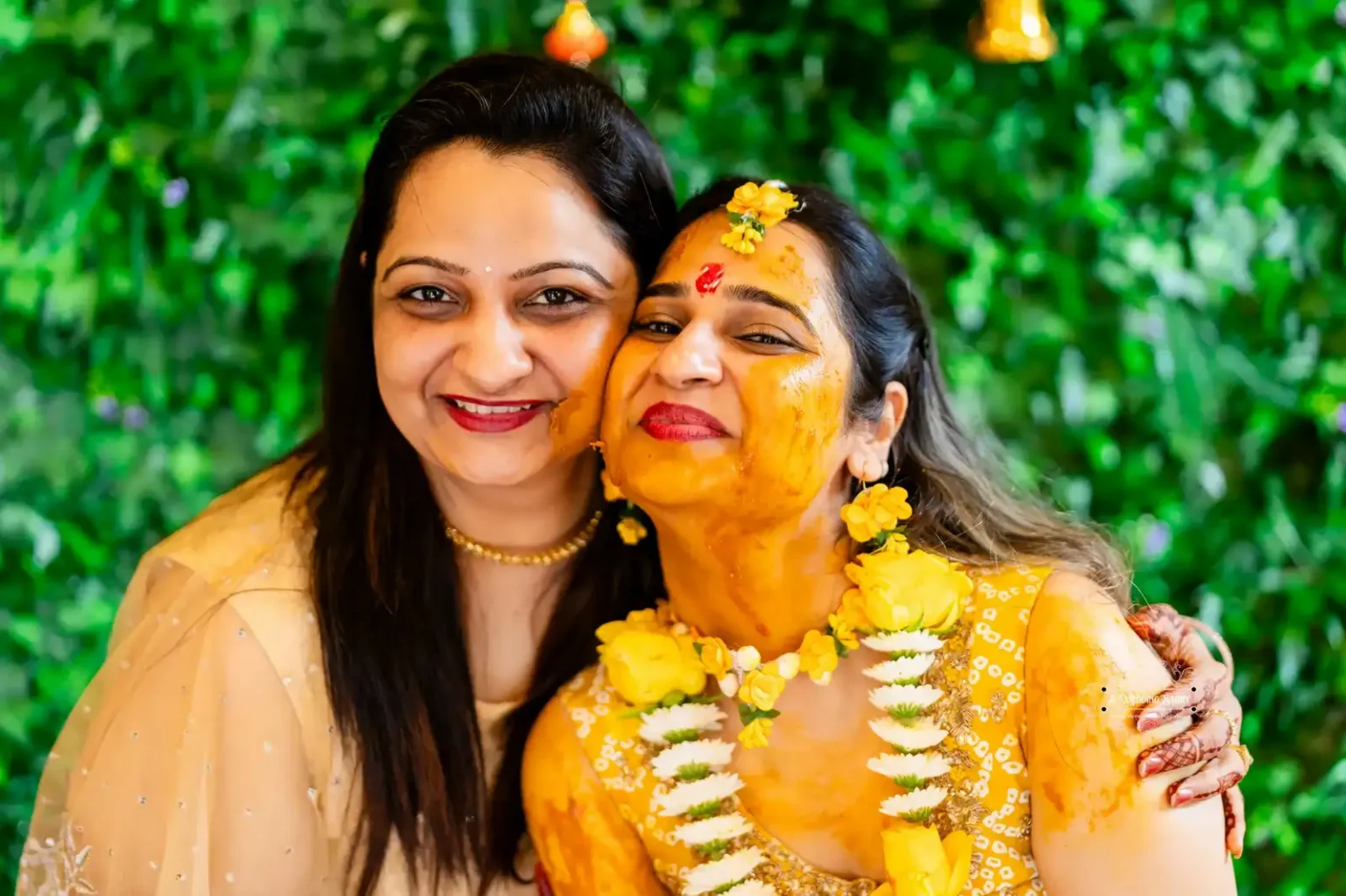 Bride and her friend sharing a joyful moment during the Haldi ceremony in Wellington