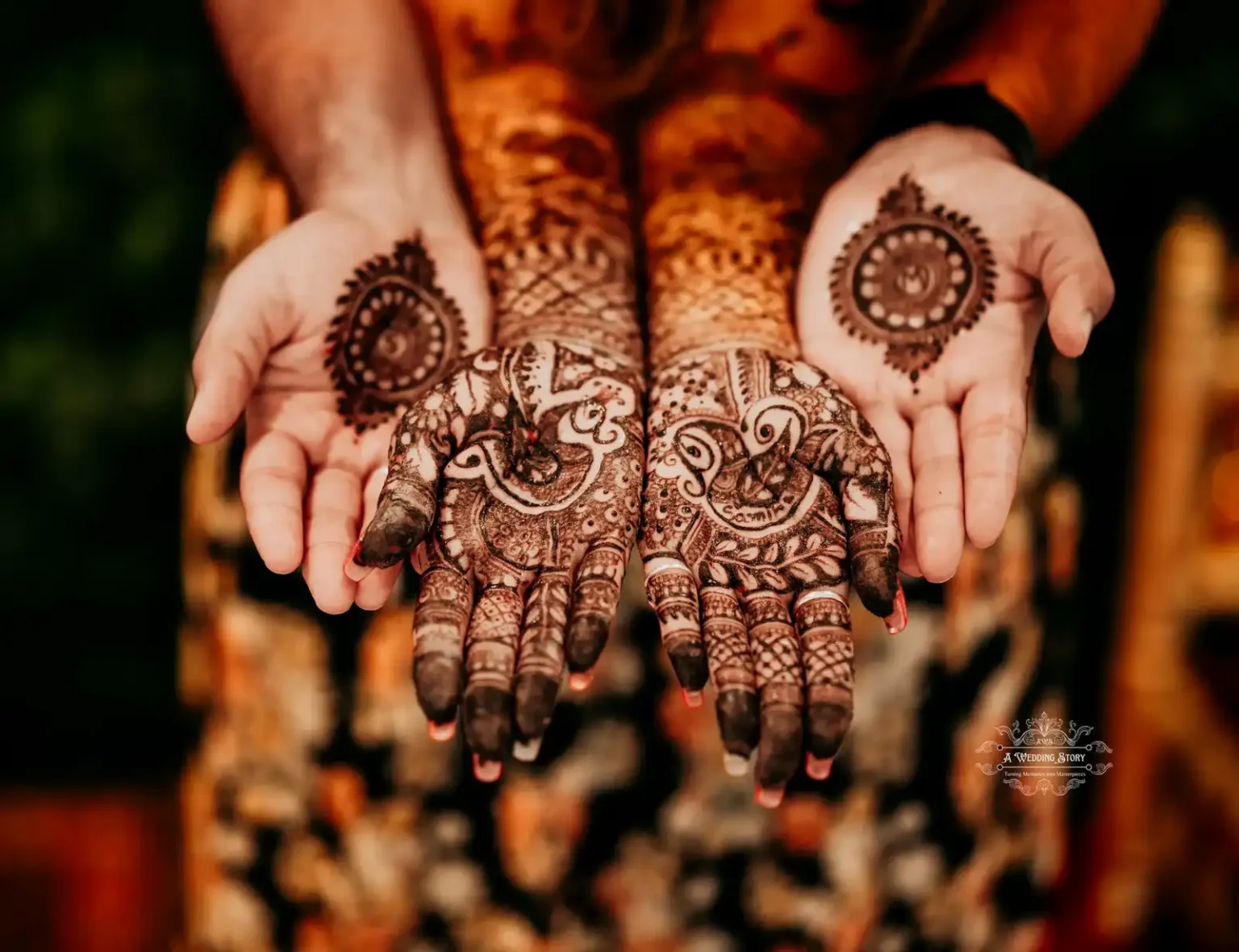 Close-up of bride and groom's hands with intricate mehndi designs, showcasing cultural motifs and artistry during a pre-wedding celebration in Wellington by A Wedding Story