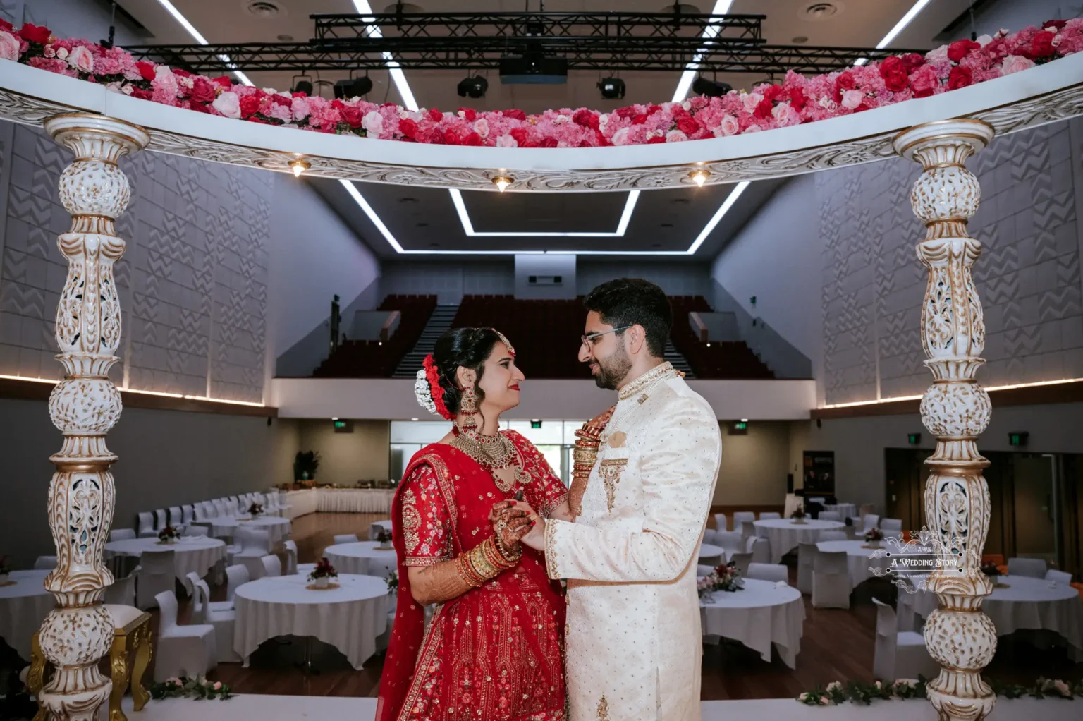 Indian bride and groom sharing a romantic moment under the wedding mandap, captured in Wellington by Wedding Photography.