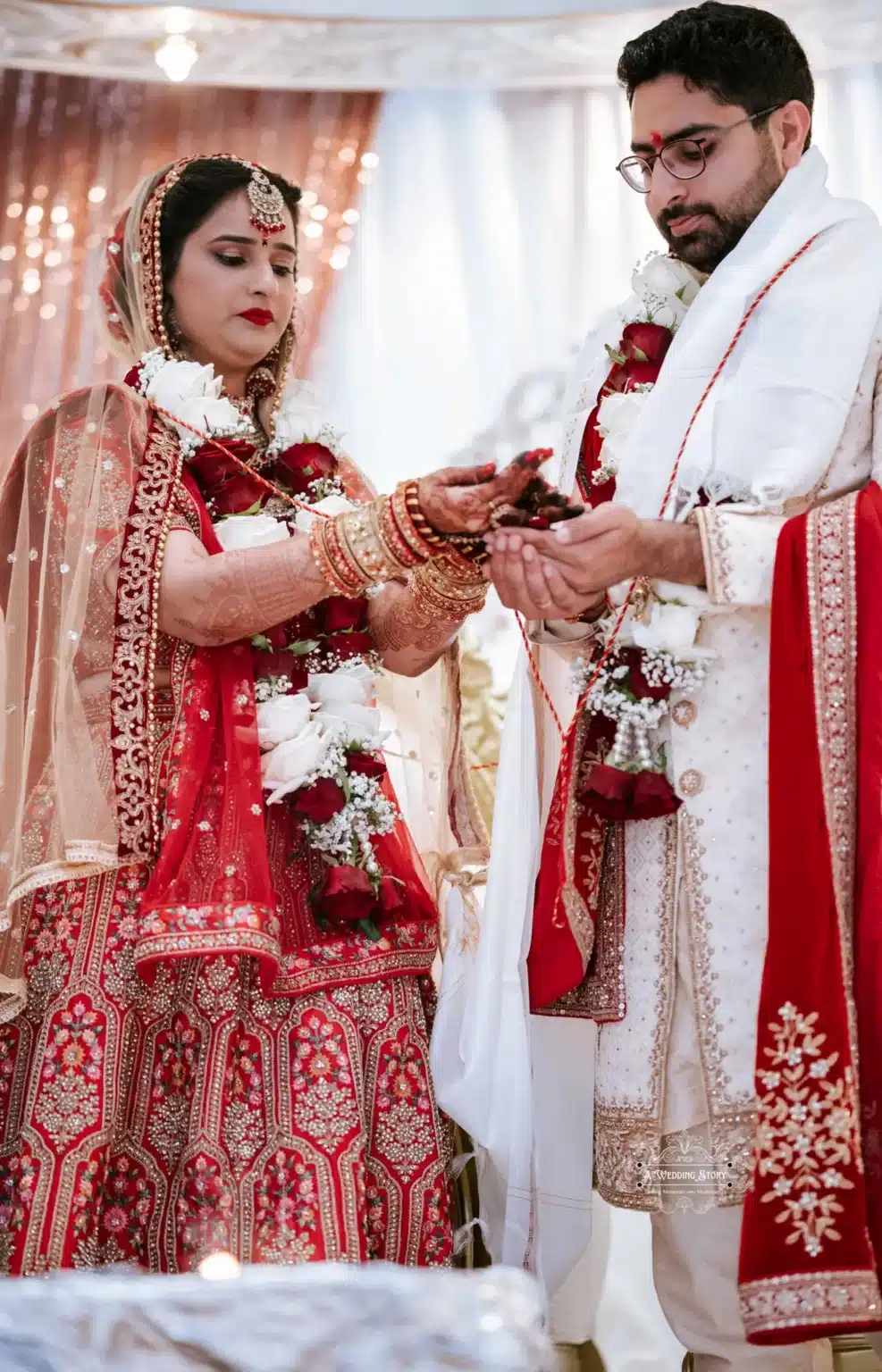 Bride and groom in traditional attire participate in a sacred wedding ritual, symbolizing unity and blessings.