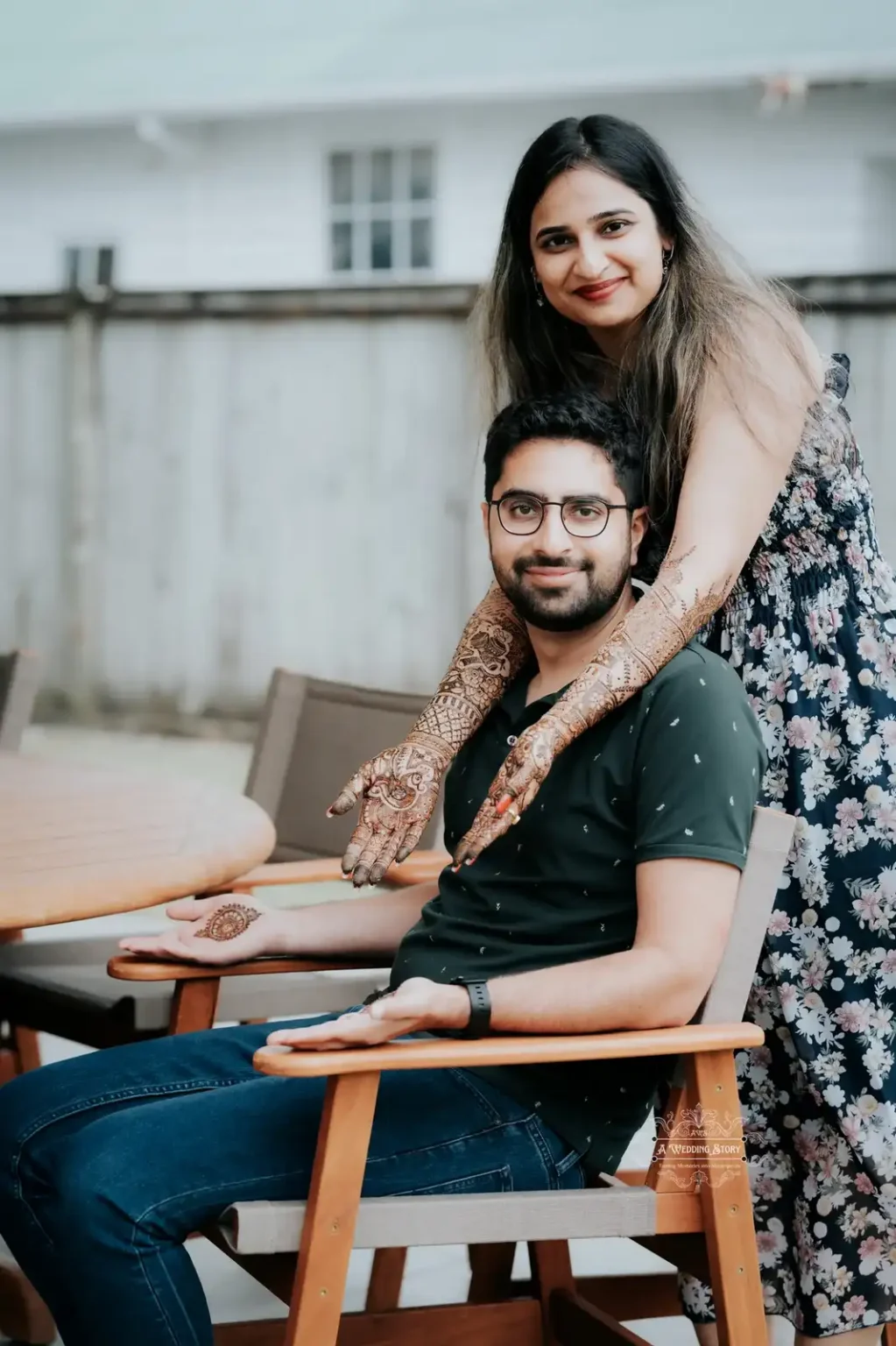 Smiling bride with intricate mehndi designs embracing her groom, who showcases his mehndi-adorned palms, during a pre-wedding photoshoot in Wellington by A Wedding Story