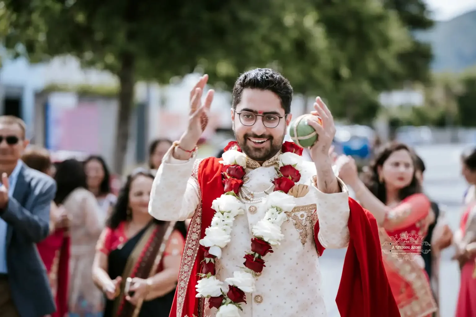 Smiling groom holding a ceremonial item and celebrating, surrounded by family, captured by Wedding Photography in Wellington