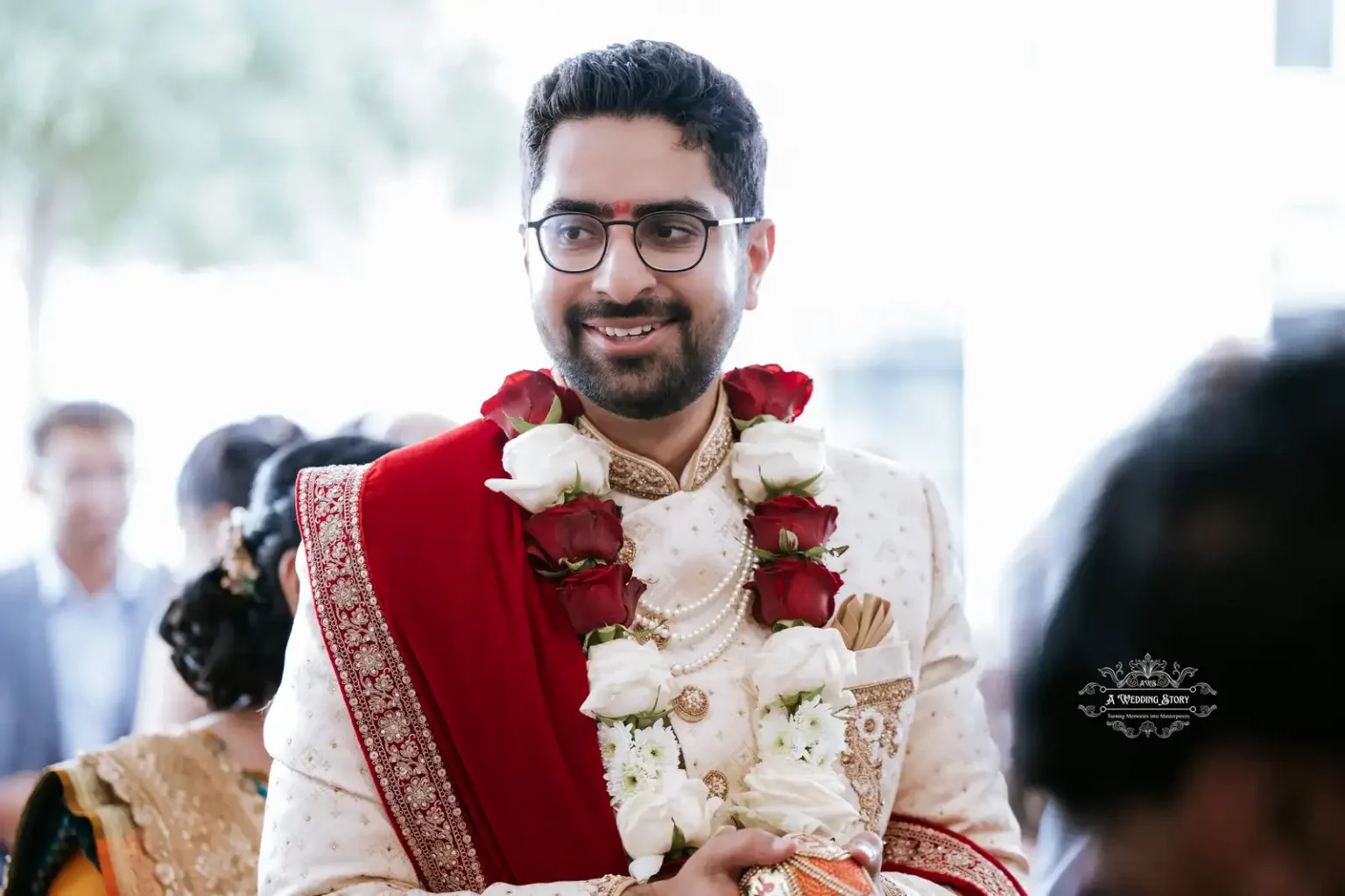 Groom smiling in traditional attire with floral garlands during wedding celebration, captured by Wedding Photography in Wellington