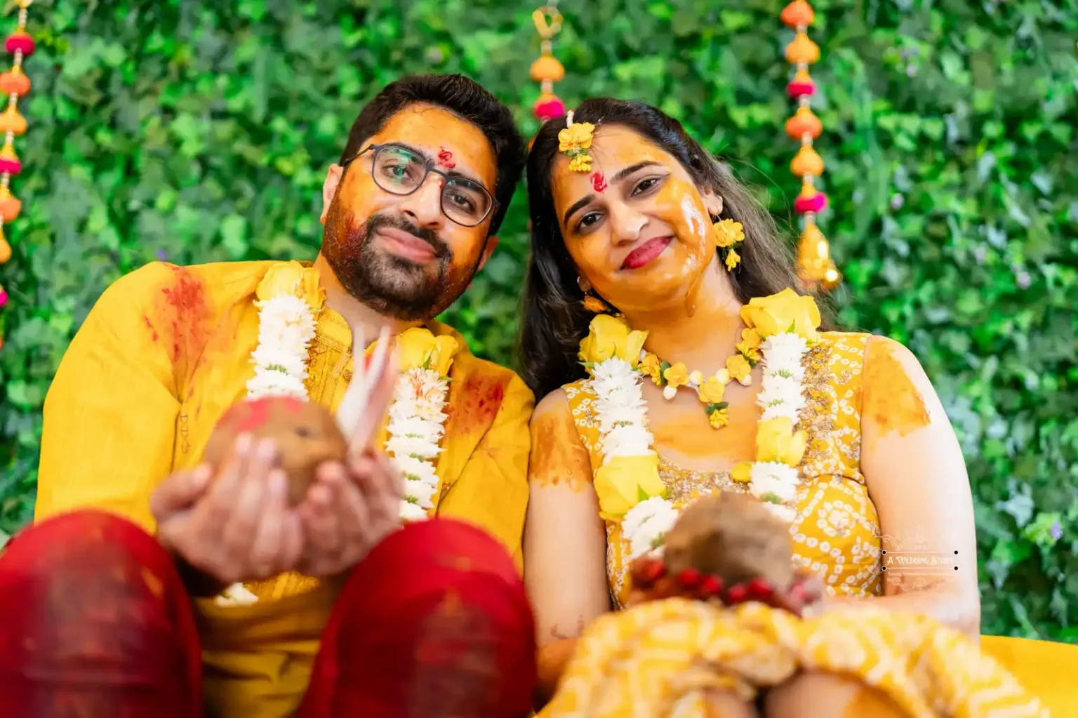 Bride and groom seated together holding a traditional coconut during Haldi ceremony, captured by Wedding Photography in Wellington, New Zealand