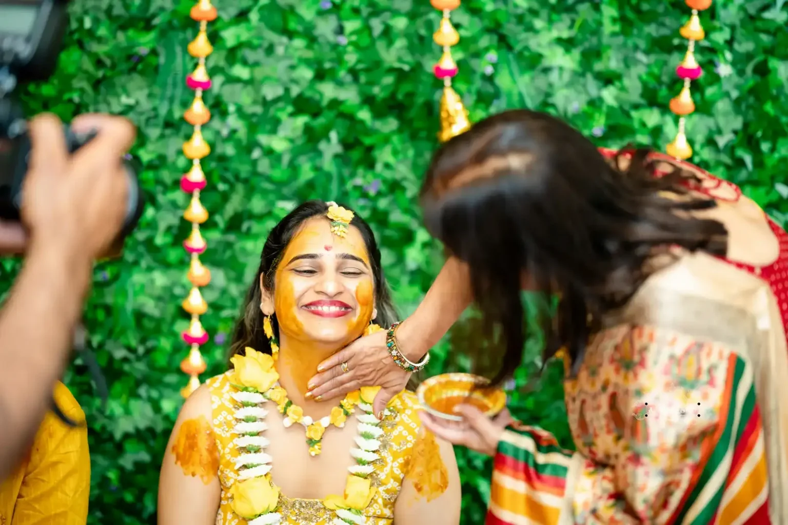 Bride smiling during Haldi ceremony as turmeric is applied, captured by Wedding Photography in Wellington