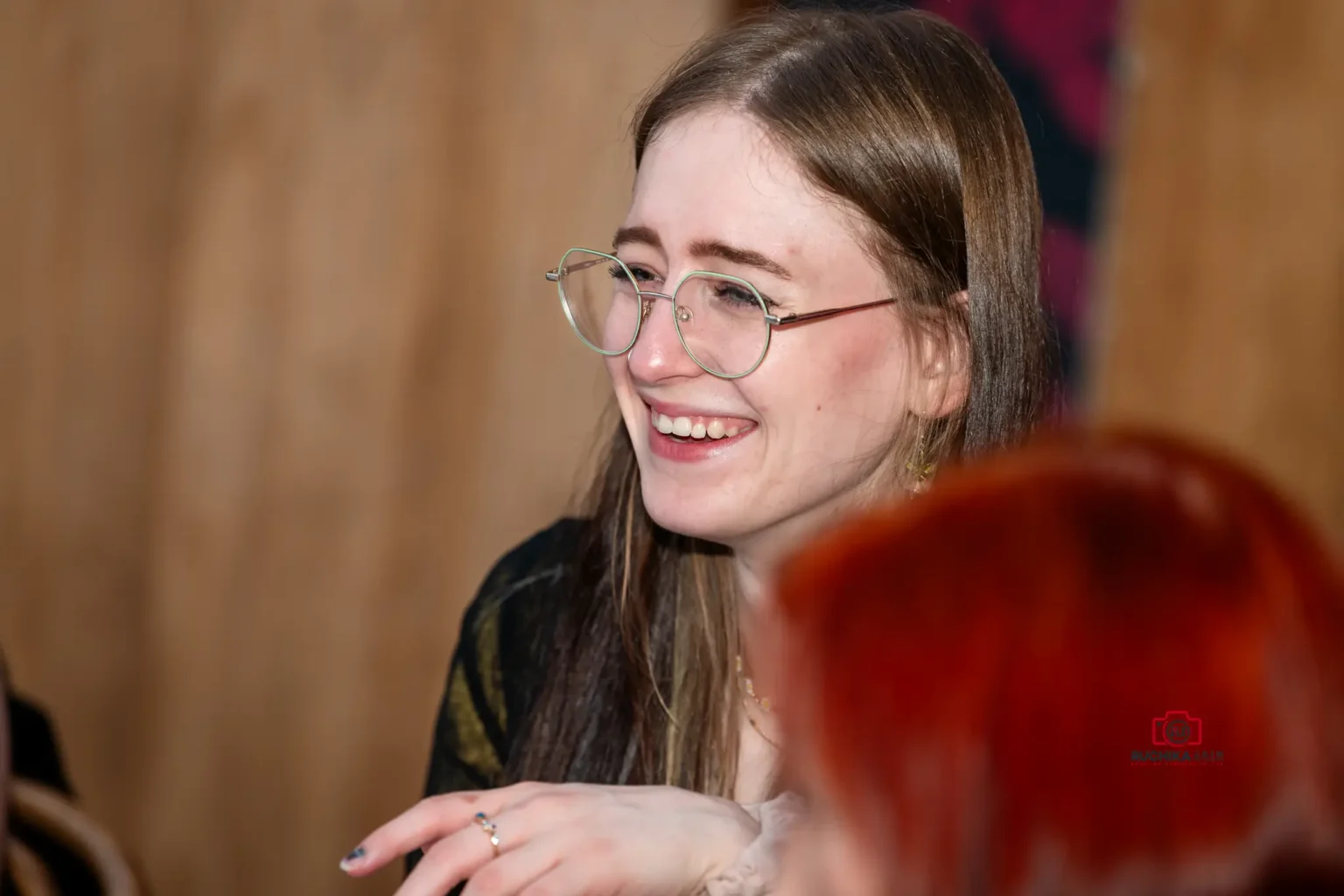 Young woman smiling and enjoying the wedding celebration in a candid moment