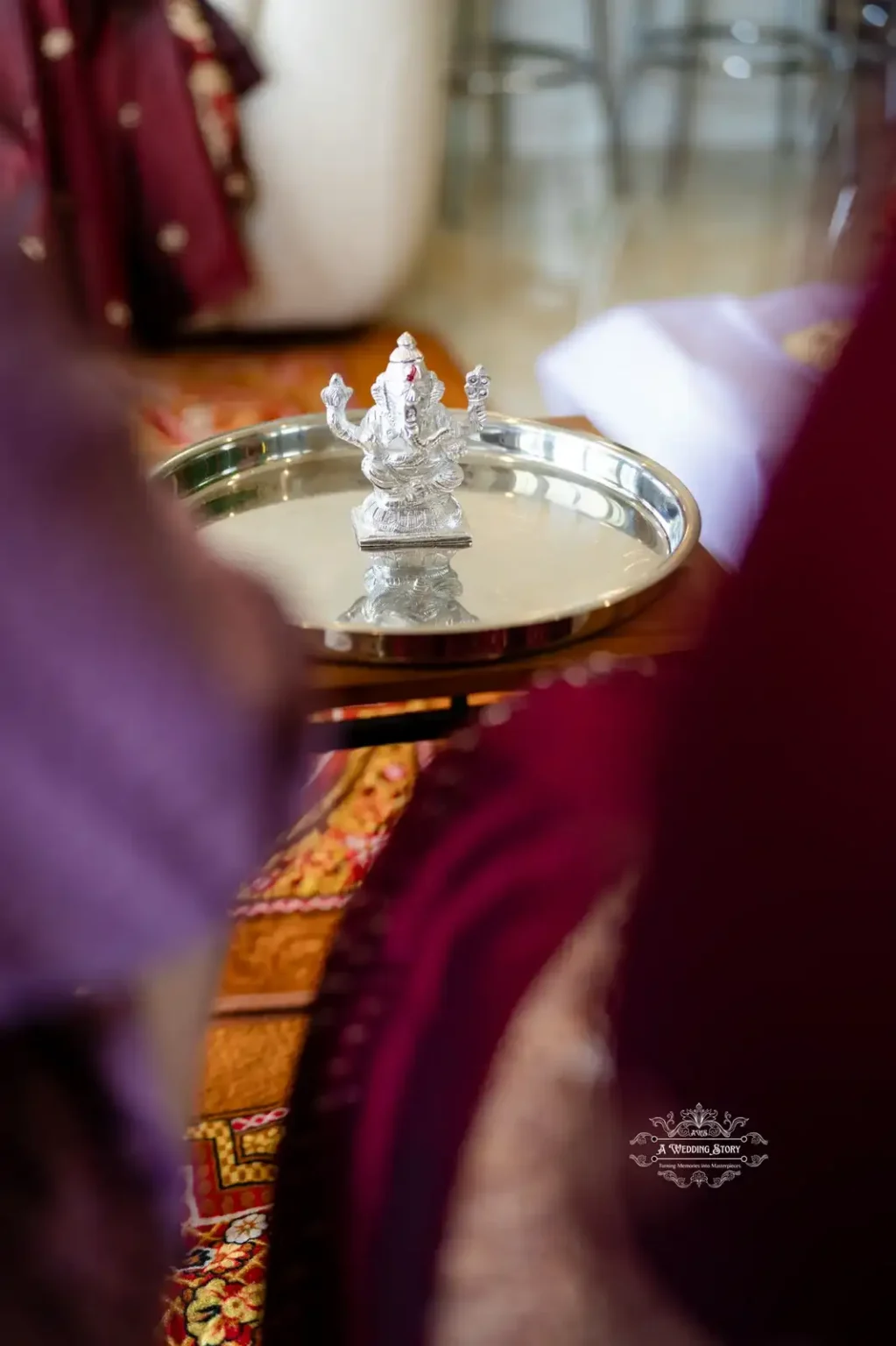 Silver idol of Lord Ganesha on a tray during a wedding ceremony, captured by Wedding Photography in Wellington