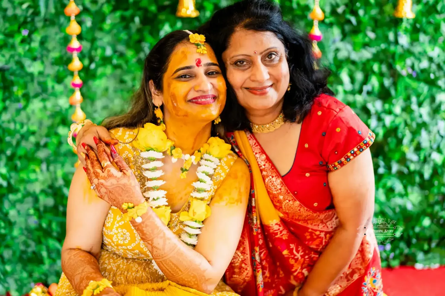 Smiling bride with her mother, both adorned in traditional attire during Haldi ceremony in Wellington