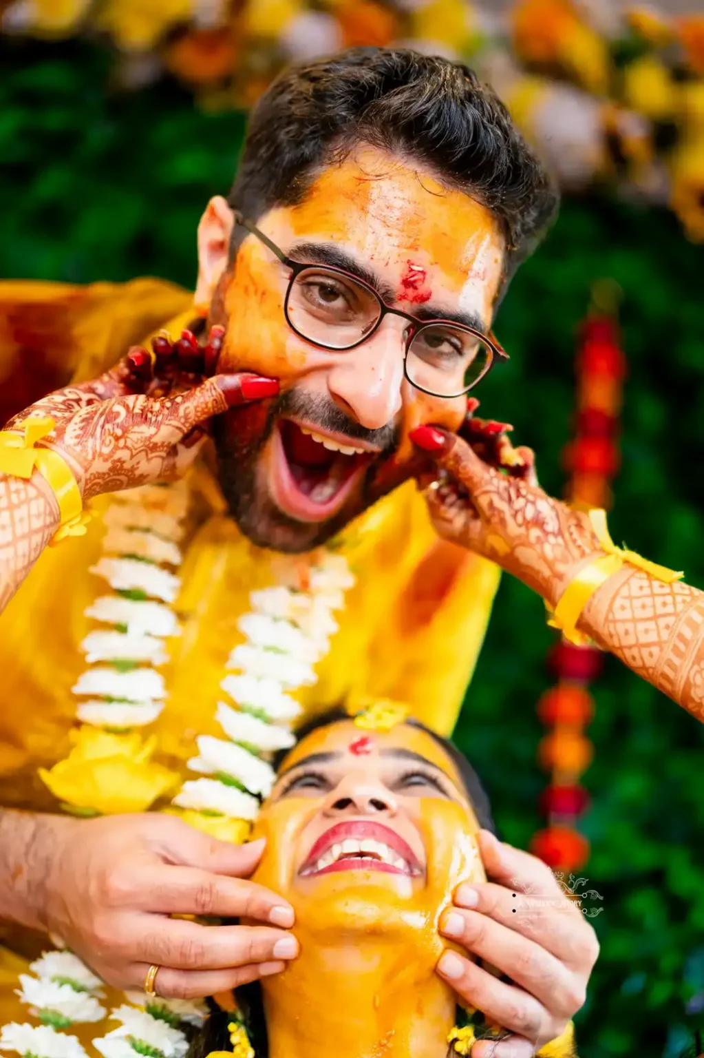 Bride playfully pinching groom’s cheeks during Haldi ceremony, captured by Wedding Photography in Wellington, New Zealand