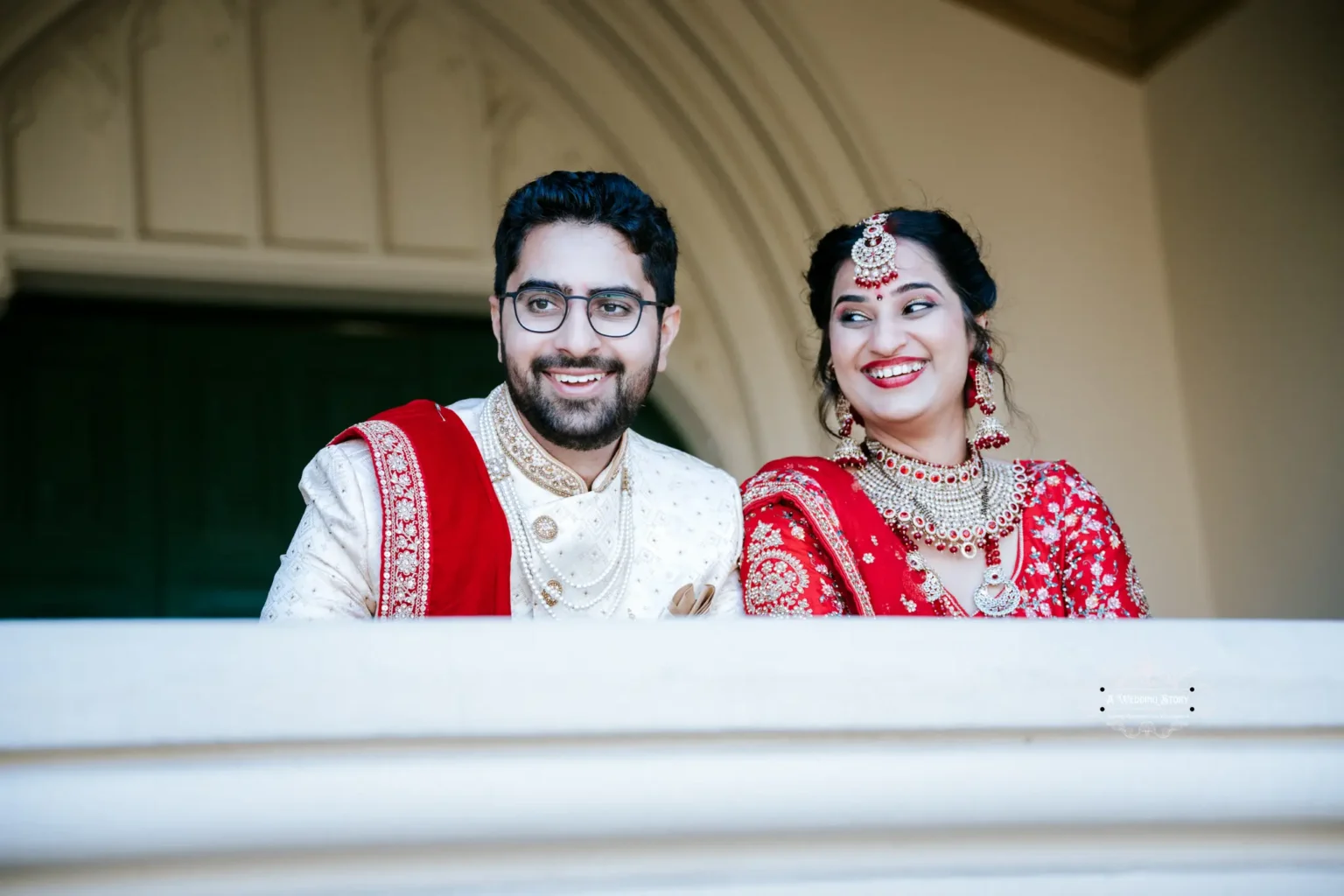 Smiling bride and groom in traditional attire at their wedding in Wellington, captured by A Wedding Story.