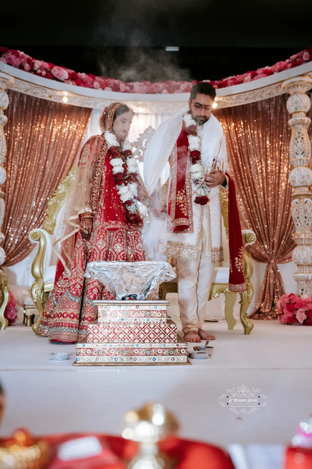 Indian bride and groom performing the sacred fire ritual at their wedding ceremony in Wellington, New Zealand, captured by Wedding Photography.