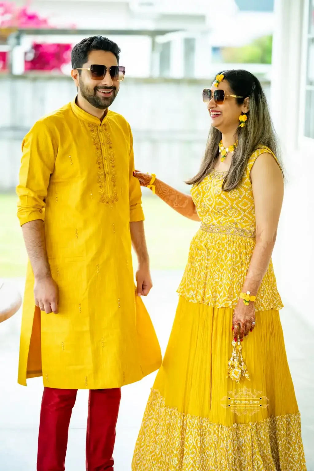 Bride and groom dressed in coordinated yellow outfits, smiling and enjoying their Haldi ceremony in Wellington.