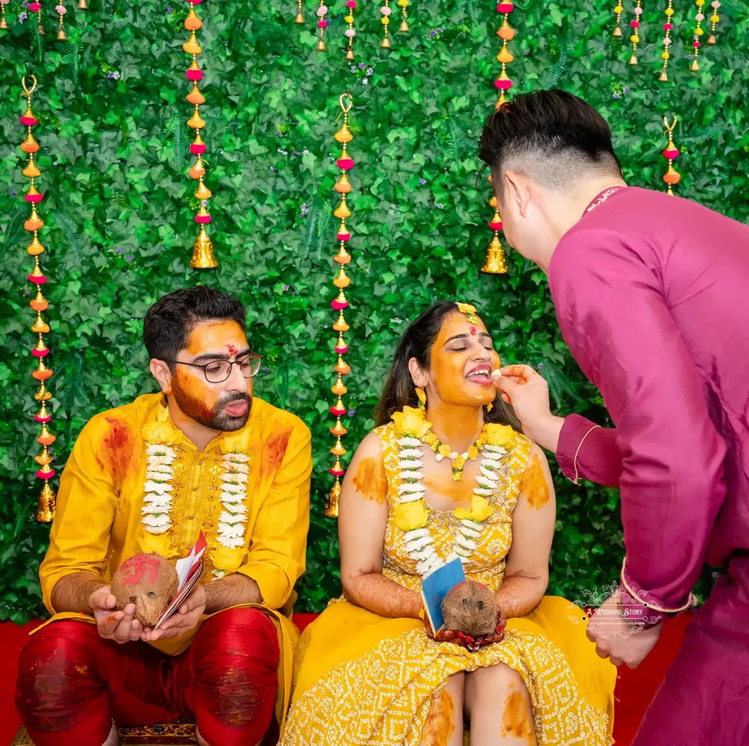 Bride receiving a sweet blessing from a family member during the Haldi ceremony in Wellington.