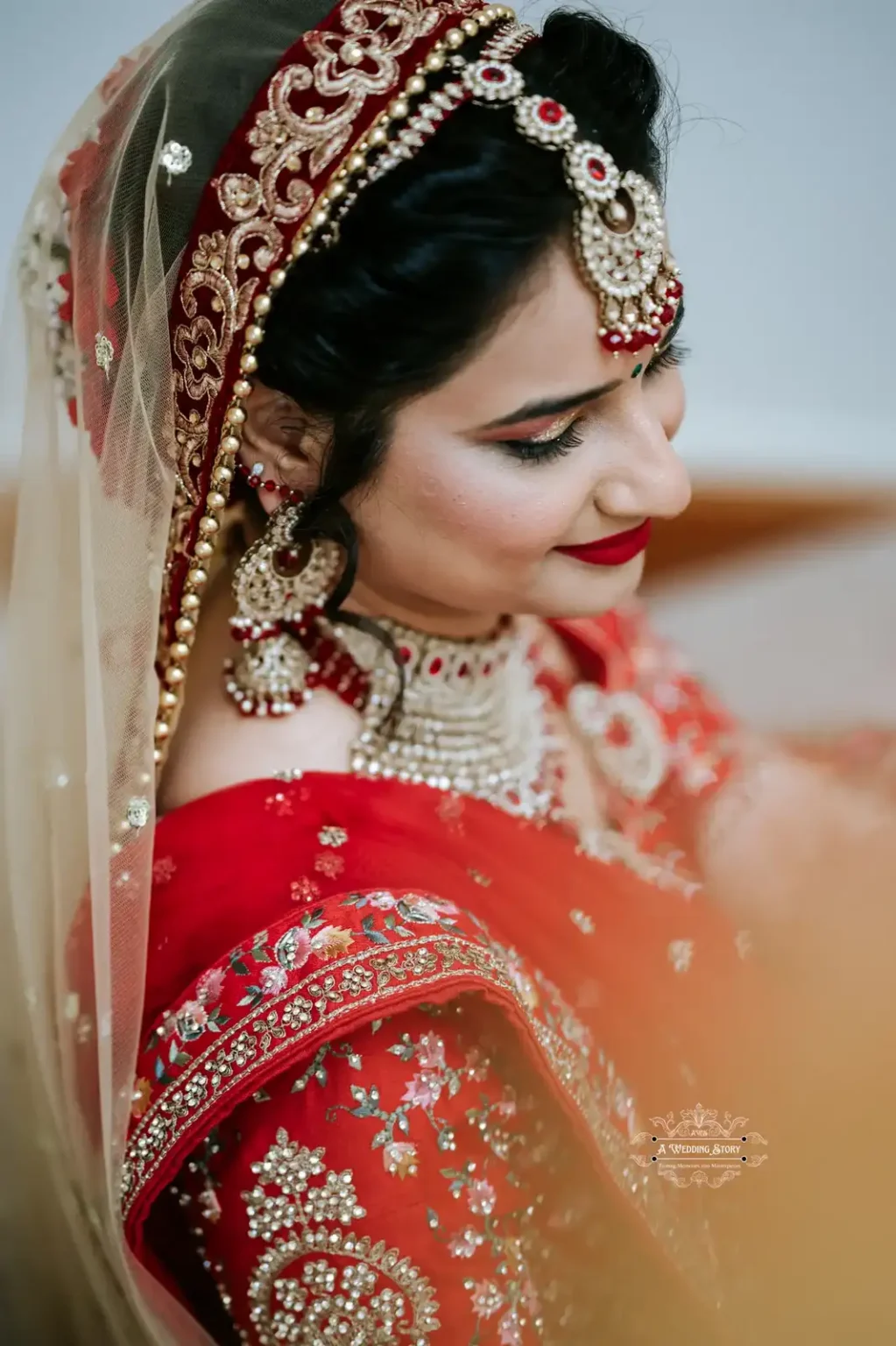 Close-up portrait of a bride in traditional red and gold bridal attire, captured by Wedding Photography in Wellington