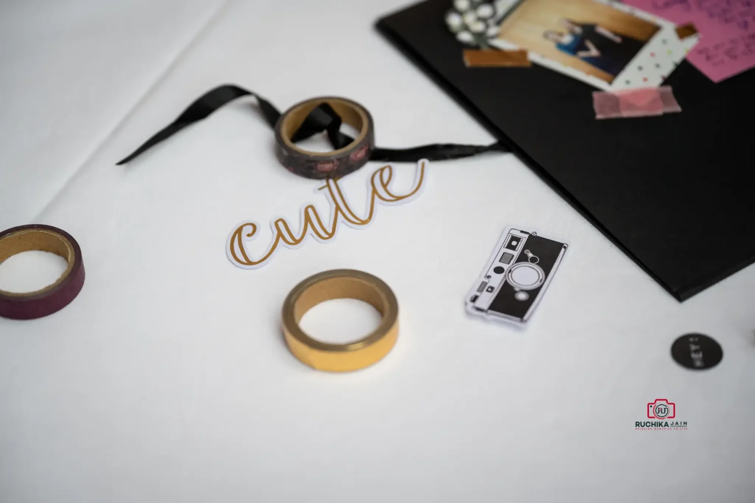 Close-up of wedding decor items including scrapbook materials, washi tape, and cute accents