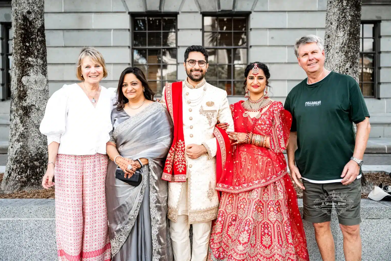 Bride and groom posing with family and friends during their wedding celebration in Wellington, New Zealand.