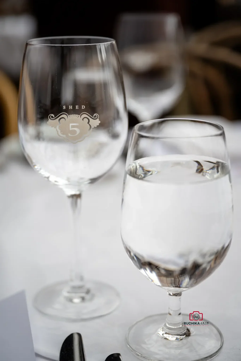 Close-up of elegant wine and water glasses at a wedding table setting in Wellington