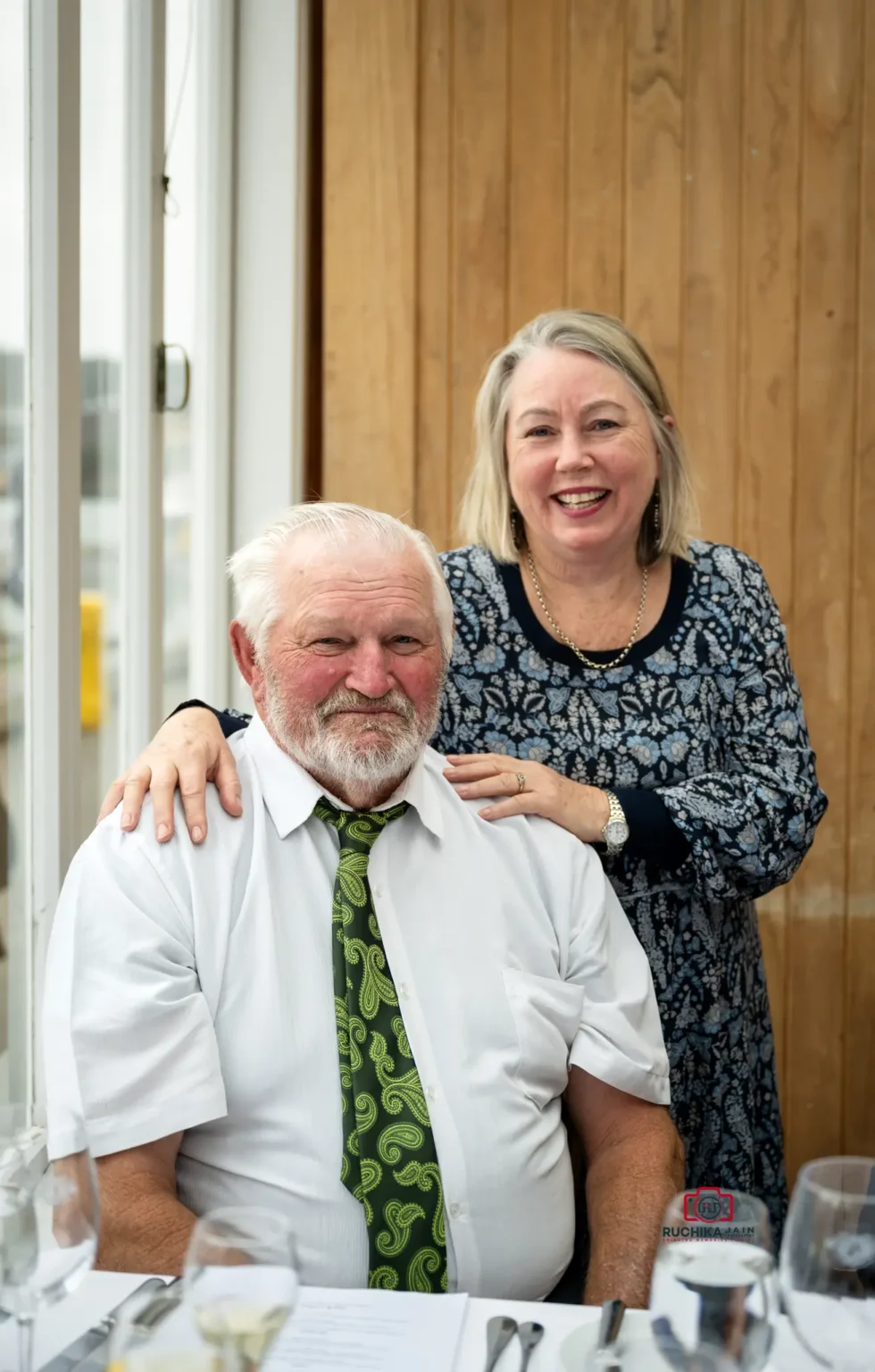 Two wedding guests smiling and posing together during the reception in Wellington