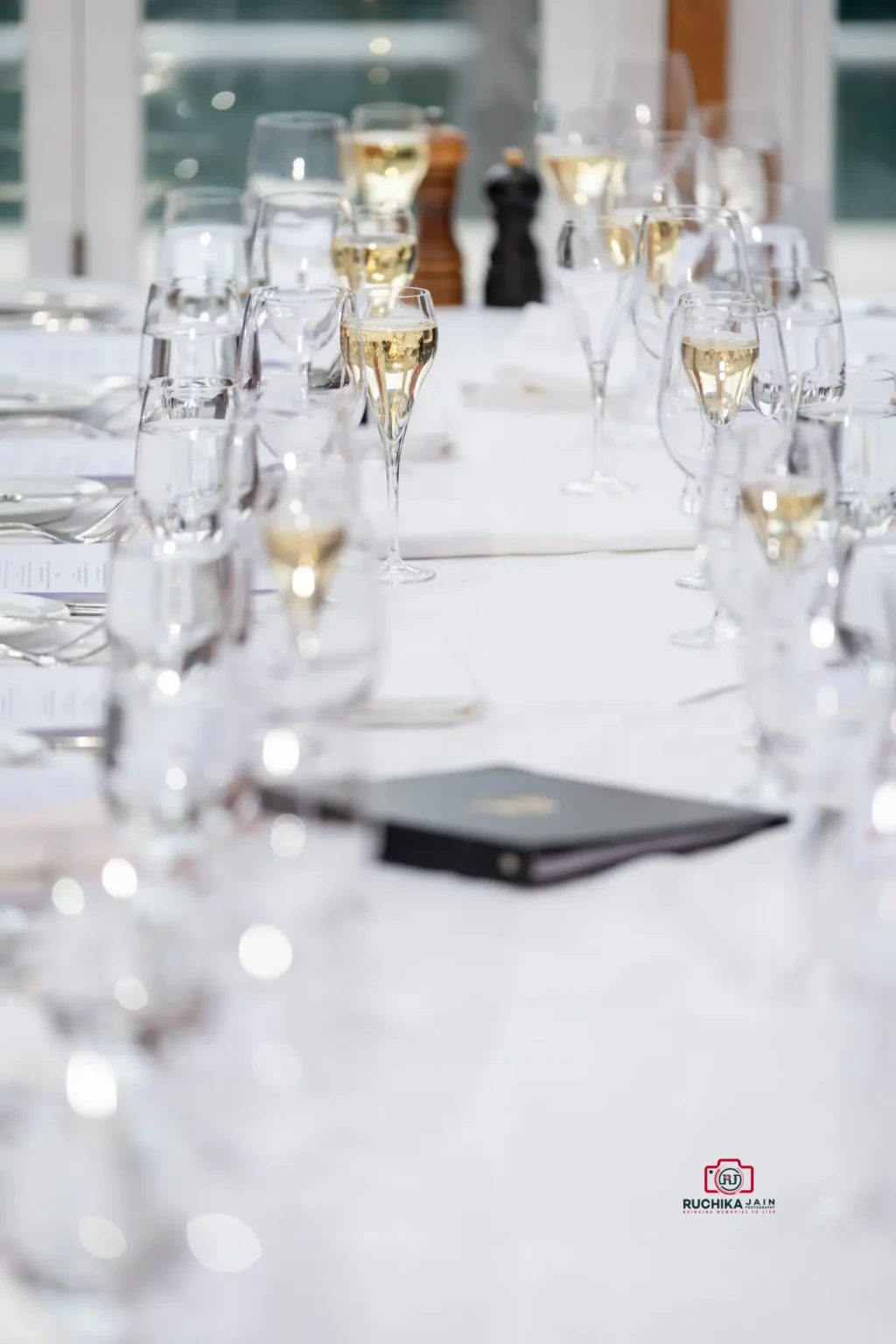 Close-up of a wedding table setting with champagne glasses arranged for guests