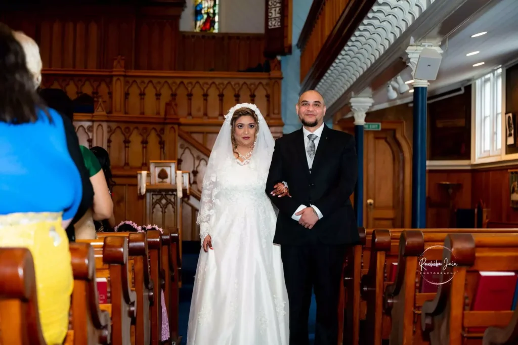 A bride and groom walking down the aisle during a traditional church wedding ceremony in New Zealand