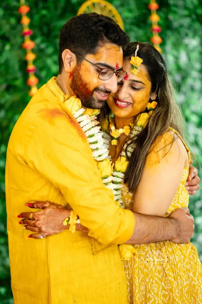 Bride and groom share an affectionate embrace during Haldi ceremony, captured by Wedding Photography in Wellington, New Zealand