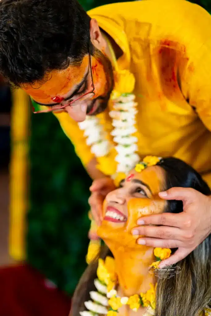 Groom lovingly holding bride’s face with joyful smiles during Haldi ceremony, captured by Wedding Photography in Wellington, New Zealand