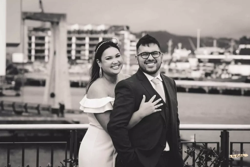 A candid black-and-white portrait of a happy couple during their waterfront wedding shoot in Wellington, captured by A Wedding Story.