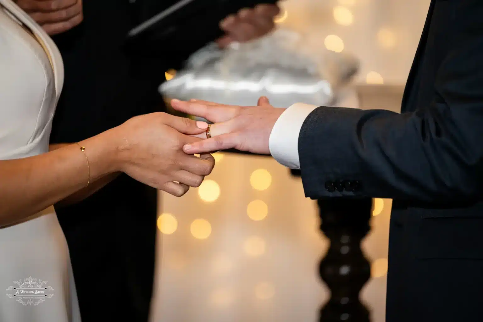 Close-up of bride placing the wedding ring on the groom’s finger during an intimate ceremony in Wellington, New Zealand.