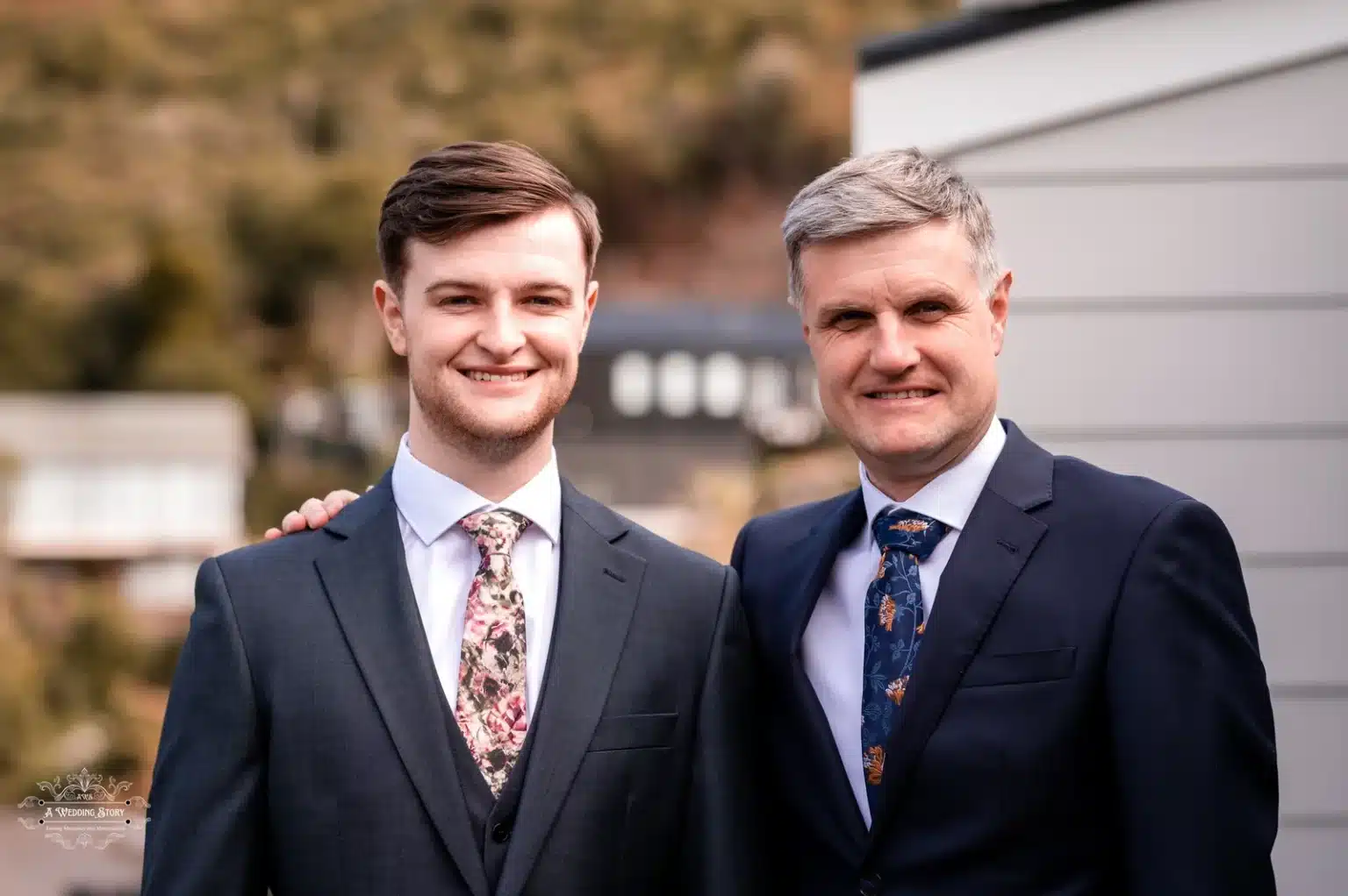 Groom and his father posing outdoors on a sunny wedding day in Wellington, New Zealand.