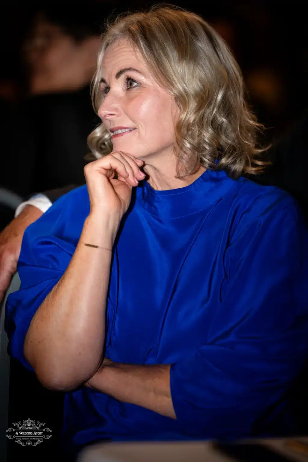 Woman guest in blue dress at wedding reception, captured during a Wellington wedding celebration.