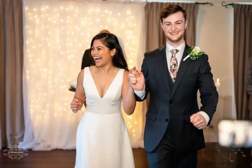 Happy bride and groom holding hands as they exit their wedding ceremony in Wellington, smiling with joy.