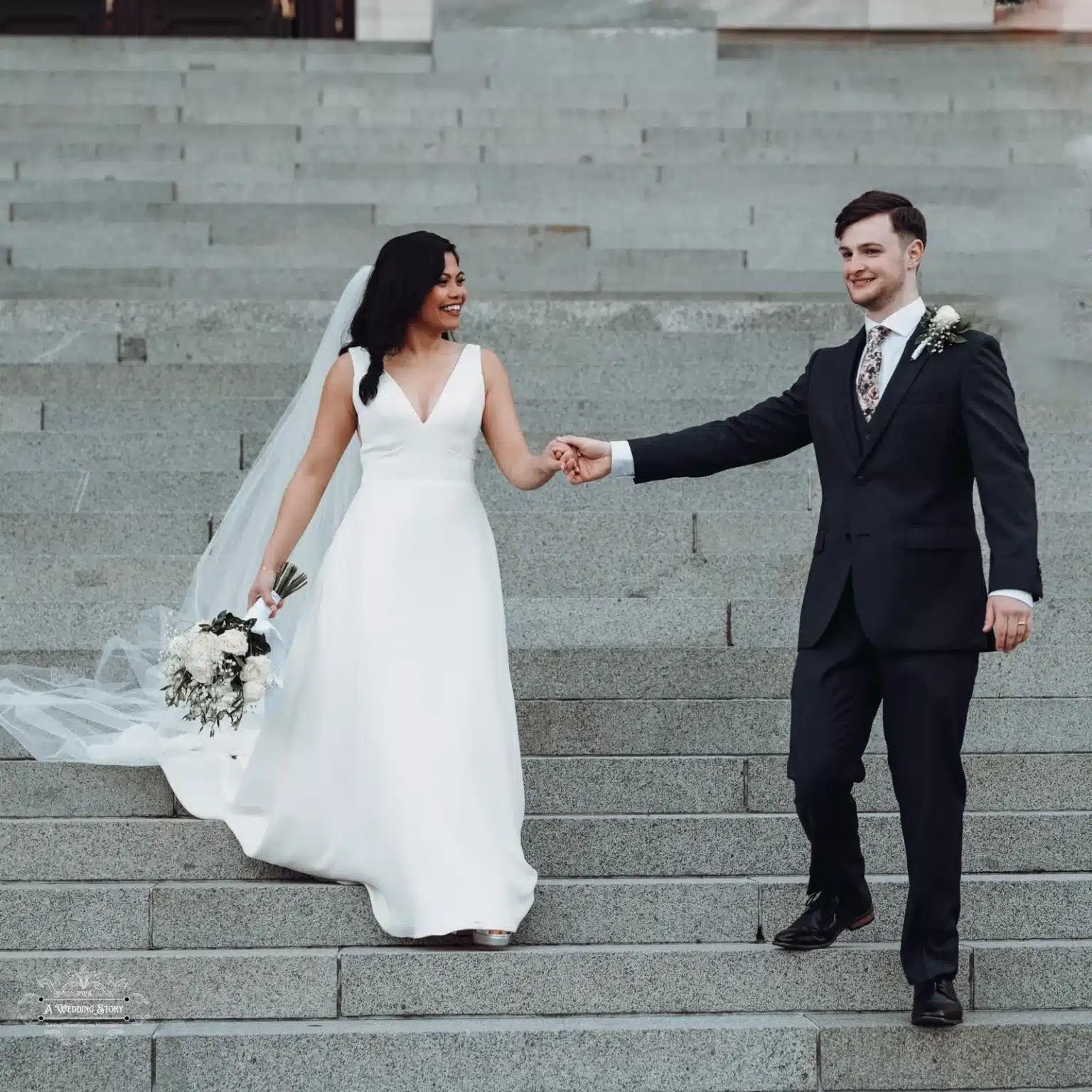 Pauline and Jackson walking hand-in-hand on the Parliament steps in Wellington.