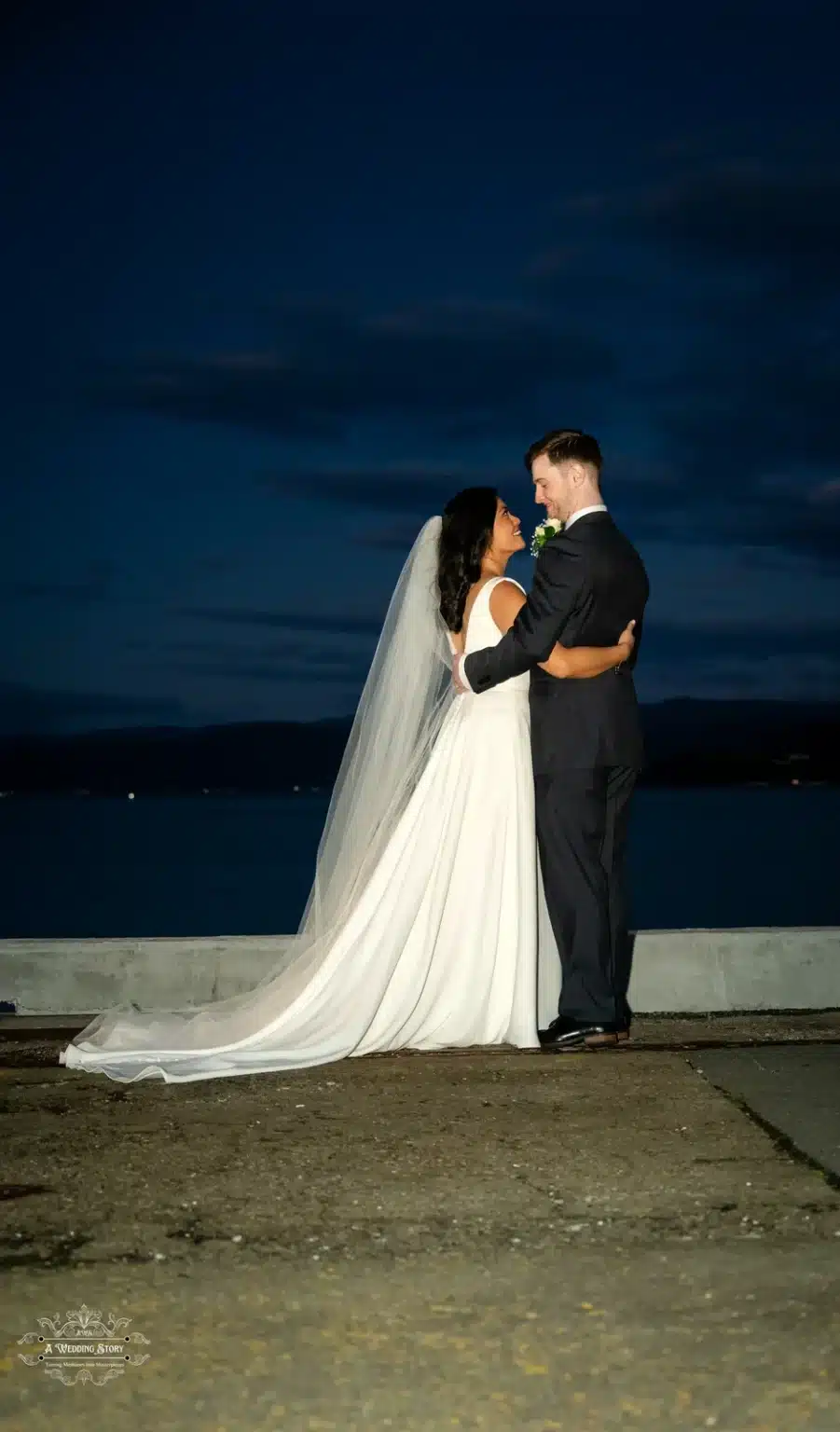 Newlyweds embrace during a romantic night photoshoot in Wellington, New Zealand