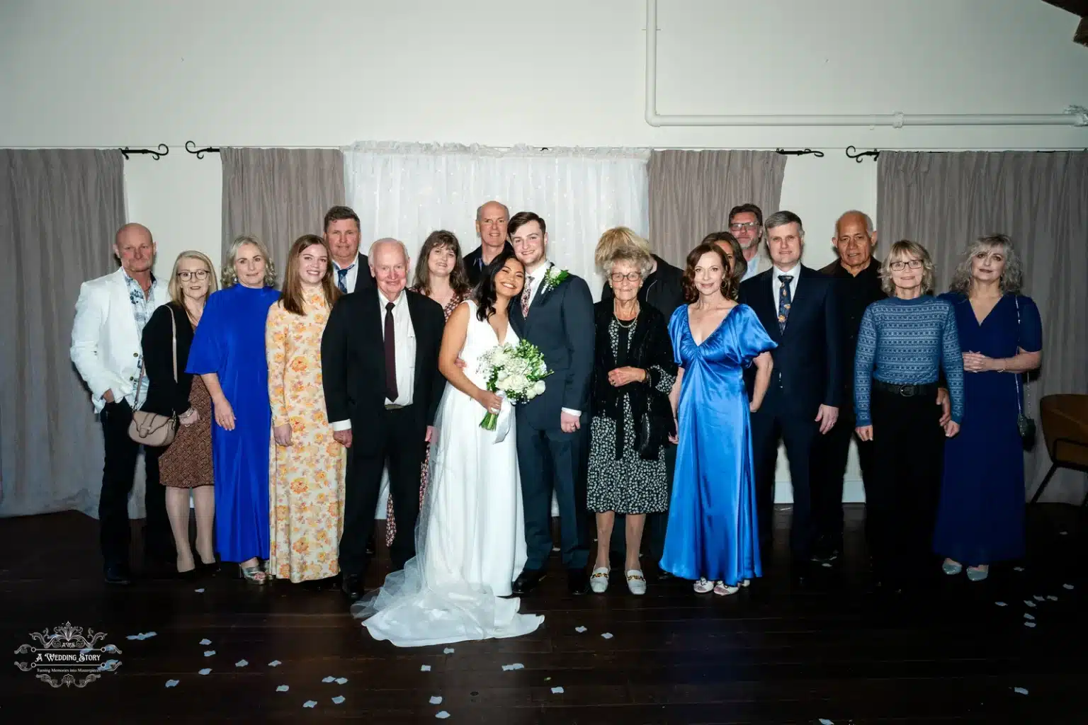 Bride and groom posing with family and friends at their wedding in Wellington, New Zealand.