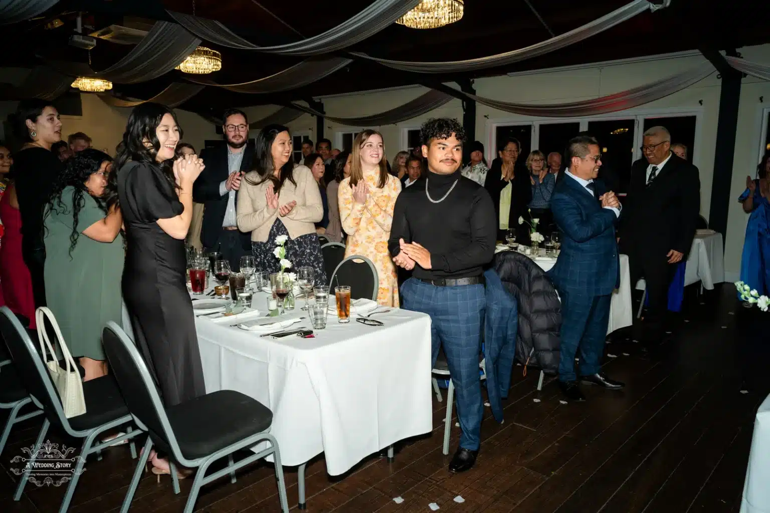 Wedding guests clapping and applauding at the wedding reception in Wellington, New Zealand.