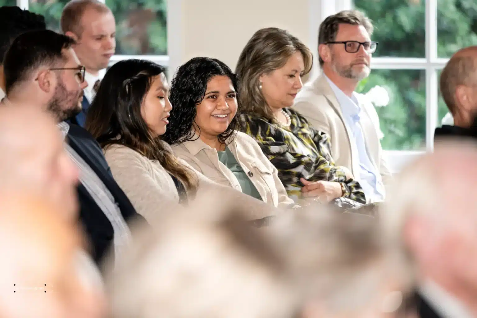 Guests seated and smiling while enjoying the wedding ceremony in Wellington, New Zealand.