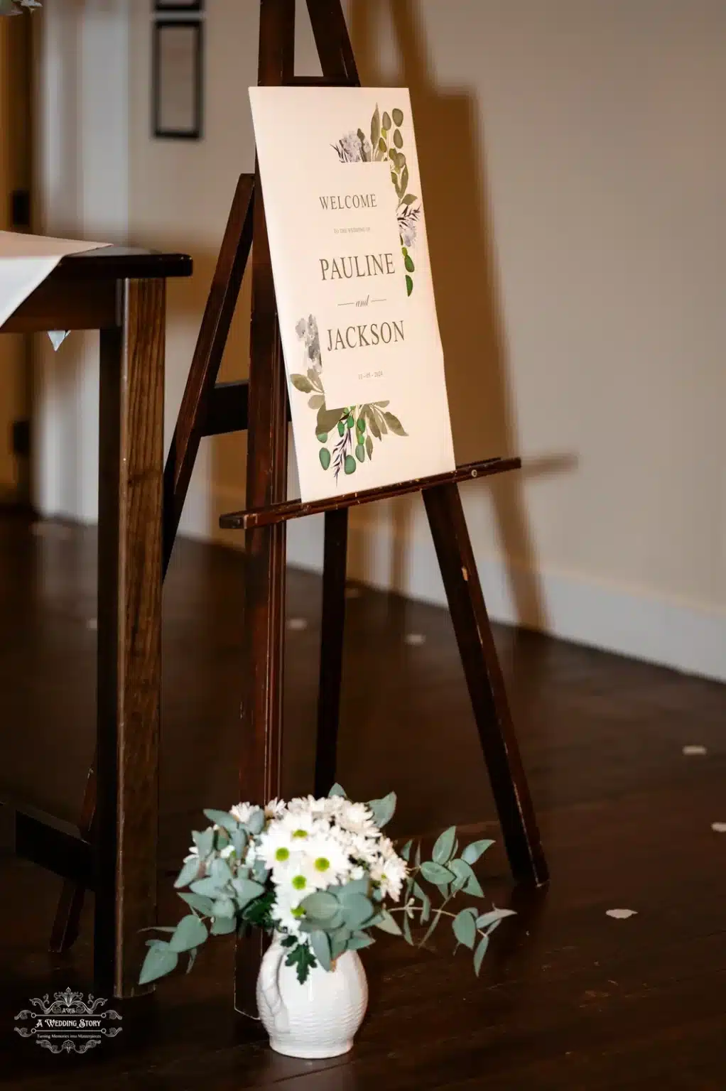 Wedding welcome sign for Pauline and Jackson's special day, with floral decorations and a simple wooden easel.