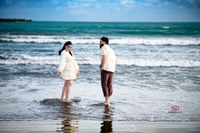 Bride and groom standing by the blue sea during their beach elopement in Wellington