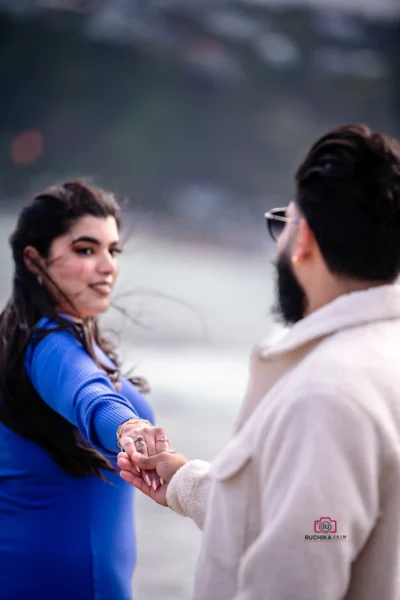 Close-up of a couple holding hands on the beach during their elopement in Wellington