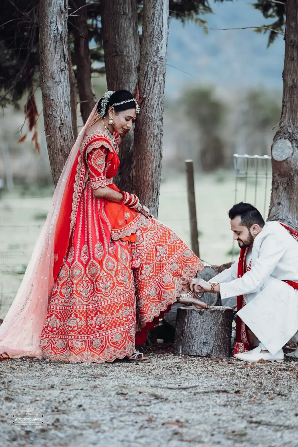 Groom assisting the bride with her anklet during a heartfelt Gujarati wedding ritual in Wellington, New Zealand