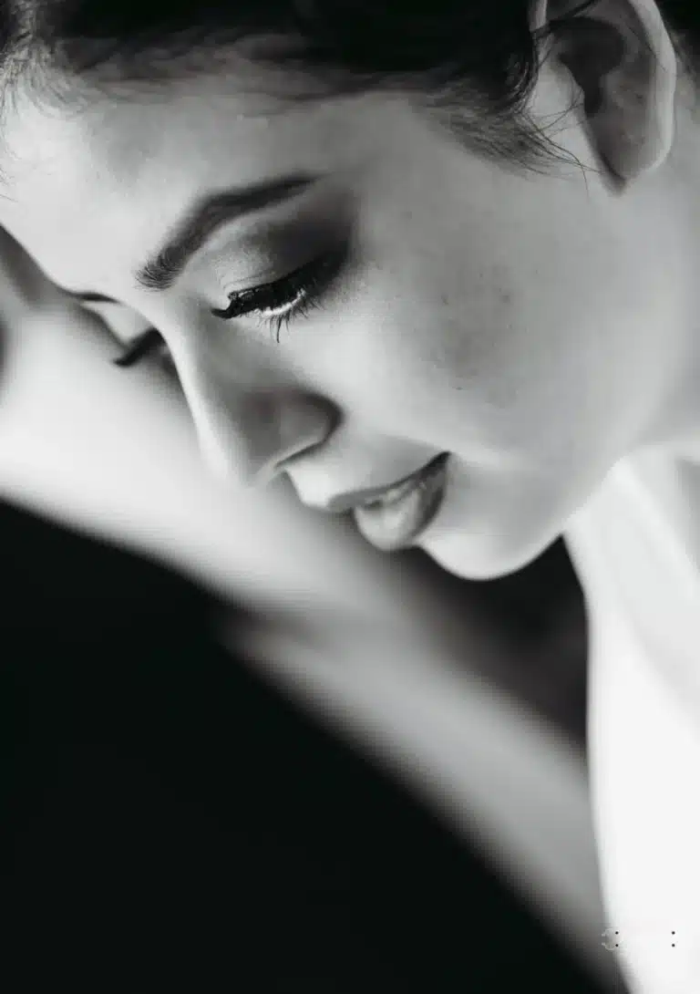 Black and white close-up of an Afghan bride, highlighting her serene expression and makeup details before her wedding in Wellington.