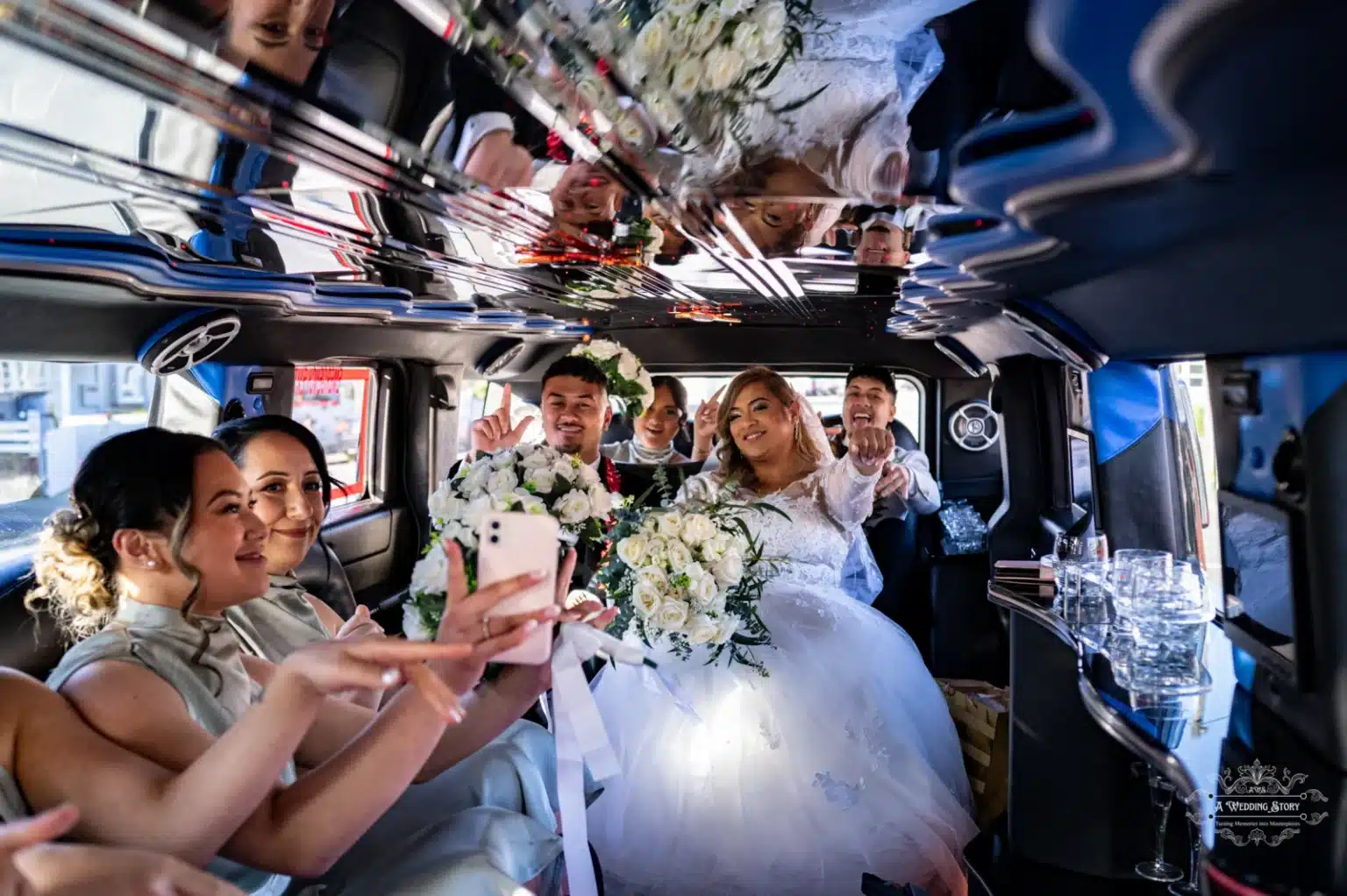 Bride and groom with friends enjoying a celebratory moment inside a wedding limousine, sharing laughter and gestures of joy in a stylish black-and-white setting.